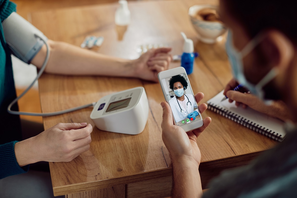 Close-up of couple measuring blood pressure and having video cal